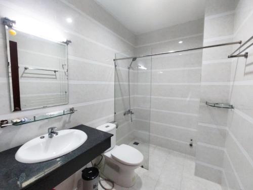 a bathroom with a toilet and a sink and a shower at Eco SaiGon Apartments in Ho Chi Minh City