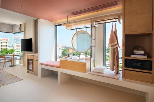 a bathroom with a large mirror and a sink at Centara Ayutthaya in Phra Nakhon Si Ayutthaya
