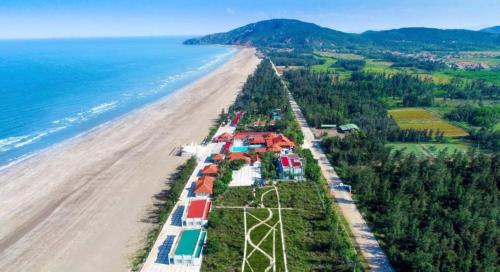 an aerial view of a beach and the ocean at Ruby Star Quỳnh Resort 