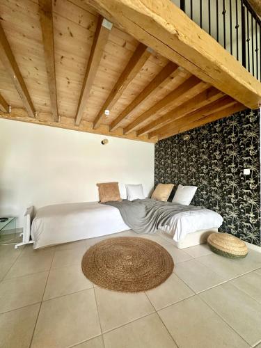 une chambre avec deux lits et un plafond en bois dans l'établissement Propriété 2 Mas, Piscine Parking, 10 Pers, à Mudaison