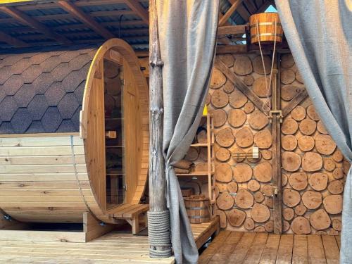 a room with a bunch of logs in a room with curtains at Готель Довбуш in Yaremche