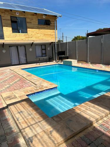 a swimming pool in front of a house at northmead lodge in Benoni