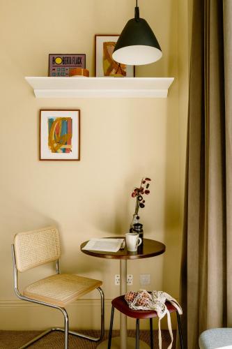 a room with a table and a chair and a desk at Mason & Fifth, Primrose Hill in London