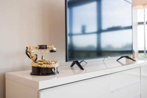 a trophy sitting on a dresser next to a television at Green View 2B2B Olympic Park in Sydney