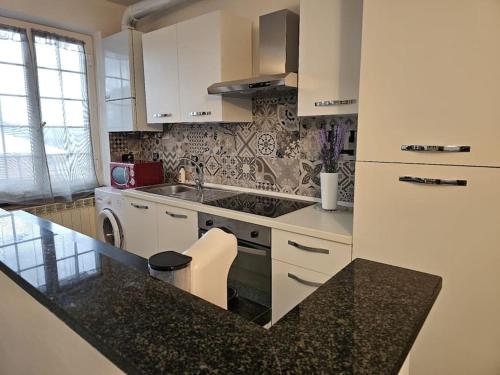 a kitchen with a sink and a stove top oven at La Casa della Lavanda in Borgo Adorno