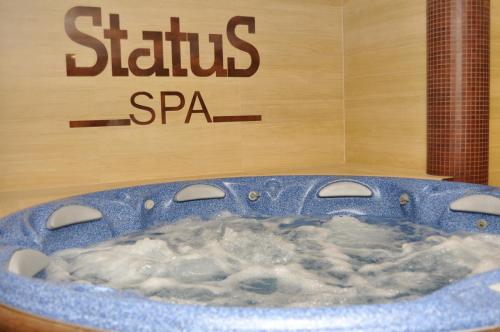 a blue bath tub filled with water in front of a sign at Status Hotel in Lviv