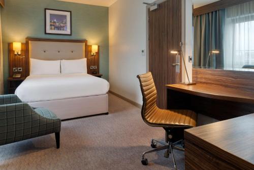 a hotel room with a bed and a desk at DoubleTree by Hilton London Angel Kings Cross in London