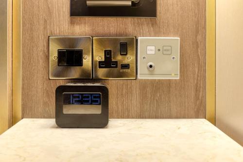 a cash register in a room with a pay phone at DoubleTree by Hilton London Angel Kings Cross in London
