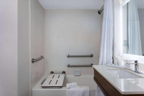a white bathroom with a sink and a toilet at La Quinta Inn by Wyndham Pensacola in Pensacola