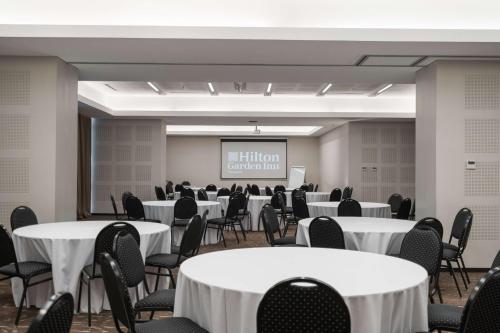 a conference room with white tables and chairs at Hilton Garden Inn Neuquen in Neuquén