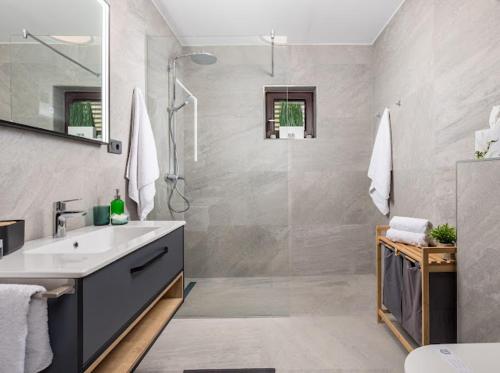 a bathroom with a sink and a shower at Apartment Marko in Lovran