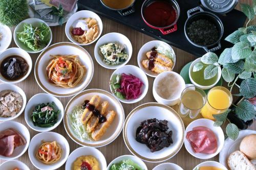 a table with plates of food in bowls on it at Best Western Plus Nagoya Sakae in Nagoya