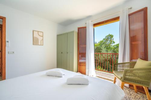 a bedroom with two beds and a balcony at G398 Ses Savines by Mallorca Villa Selection in Santanyi