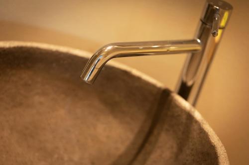 a metal sink with a faucet on top of it at B & B De Romeinse Katzei in Borgloon