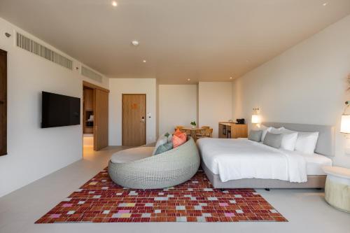 a large bedroom with a bed and a couch at Centara Ayutthaya in Phra Nakhon Si Ayutthaya