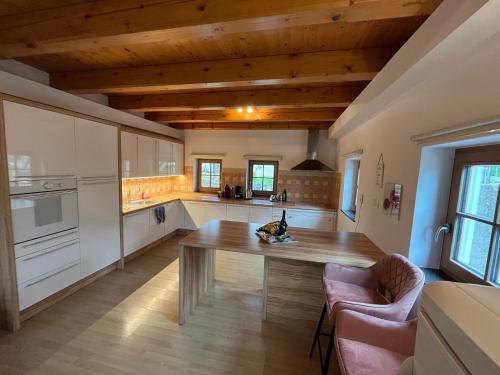 a kitchen with a wooden table in a room at Holiday Home Planina in Tržič