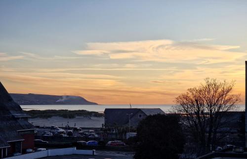 a view of a city with the ocean and a building at The Penthouse NY Loft Apartment in Barmouth