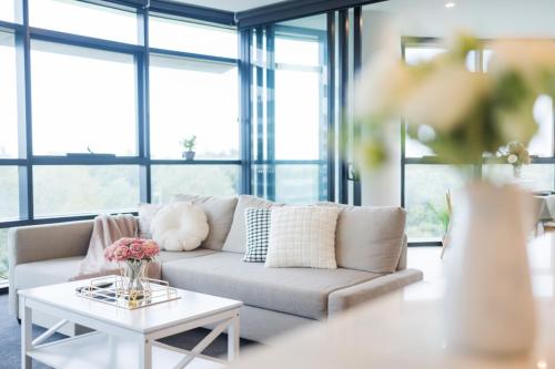 a living room with a couch and a table at Green View 2B2B Olympic Park in Sydney
