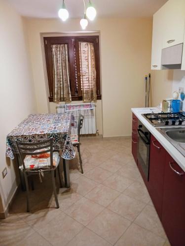 a kitchen with a table and a stove top oven at Cappuccini Guest House in San Giovanni in Fiore