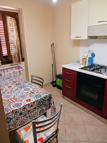 a kitchen with a table and a kitchen with a stove at Cappuccini Guest House in San Giovanni in Fiore
