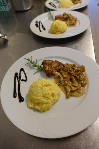 a white plate of food on a table at Hotel Bergland in Sillian