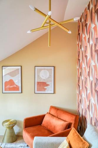- un salon avec un canapé orange et un ventilateur de plafond dans l'établissement 4D#Appart 4Pers # 1 Chambre # Commerce # Paris 15#AC, à Paris