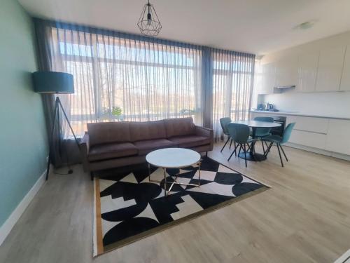 a living room with a couch and a table at Eindhoven City Apartments C 4P Free public parking in Eindhoven