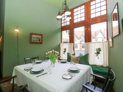 a dining room table with a white table cloth at Derry - Mar Lodge Estate in Ballater