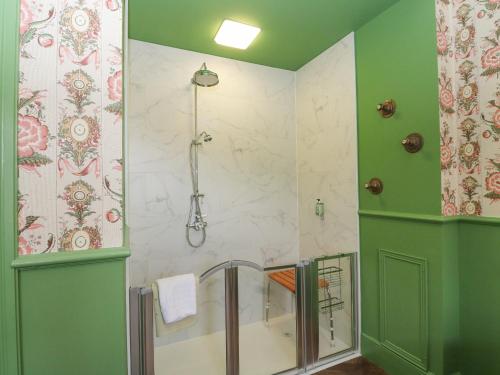 a bathroom with a shower with a glass door at Derry - Mar Lodge Estate in Ballater