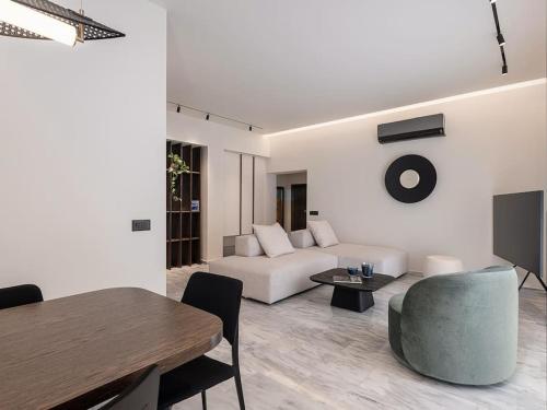 a living room with a couch and a table at ElKorin Jacuzzi Luxury Living in Chania