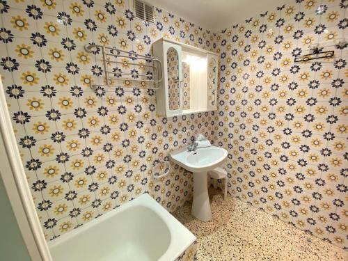 a bathroom with a sink and a bath tub at Agi Europa in Roses