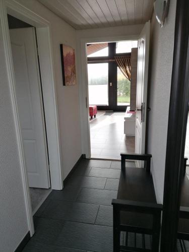 a hallway with a door open to a living room at Ferienpark Fedderwardersiel in Fedderwarderdeich