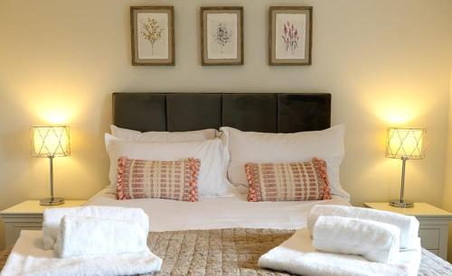 a bedroom with a large bed with two lamps at Pearmain in Spilsby