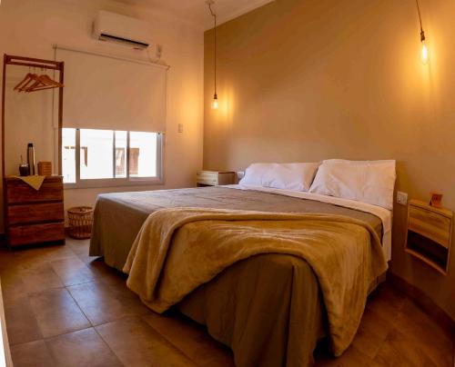 a bedroom with a large bed and a window at Cabañas Los Viñadores in Villa Unión