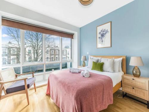 a bedroom with a bed and a large window at Pass The Keys Charming 2 - Bed Apartment in Historic Drapery Modern - Comfort in Central London in London