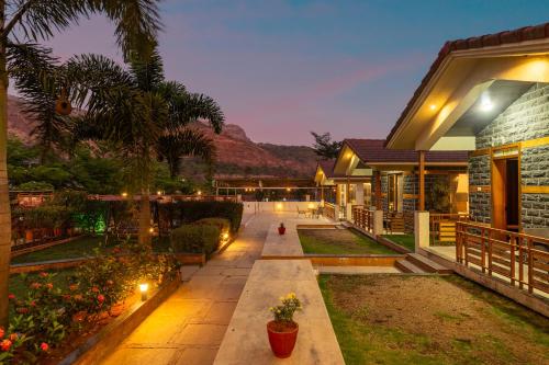 a house with a patio with lights on it at Hillside Resort Lonavala - Pawna - Mountain View in Lonavala