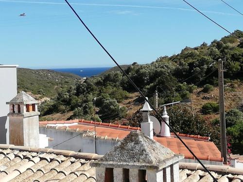 a view from the roof of a church with the ocean in the background at Casa Hortas in Vila do Bispo