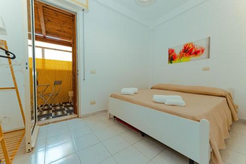 a bedroom with a bed with two towels on it at Casa di Mirabella in Donnalucata