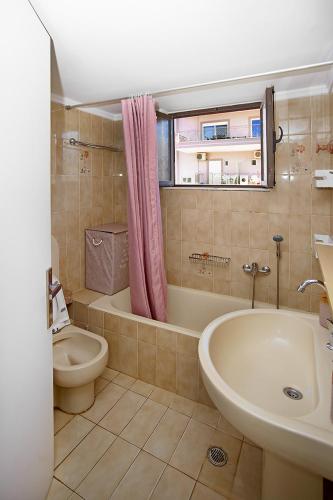 a bathroom with a tub and a toilet and a sink at Dimitra in Kyparissia