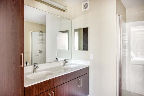 a bathroom with two sinks and a mirror at Theatre District 2br w wd gym nr theaters BOS-251A in Boston