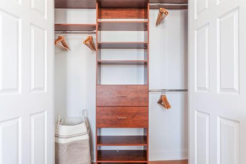 a closet with white doors and wooden shelves at Floor Harvard Sq 2BR w Gym Elevator BOS-378 in Cambridge