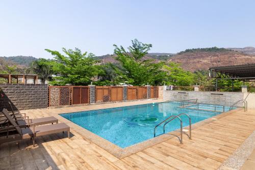 a large swimming pool on a wooden deck at Hillside Resort Lonavala - Pawna - Mountain View in Lonavala