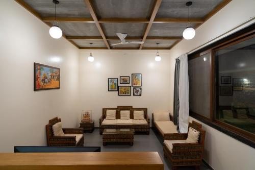 a living room with chairs and couches and a window at Hillside Resort Lonavala - Pawna - Mountain View in Lonavala