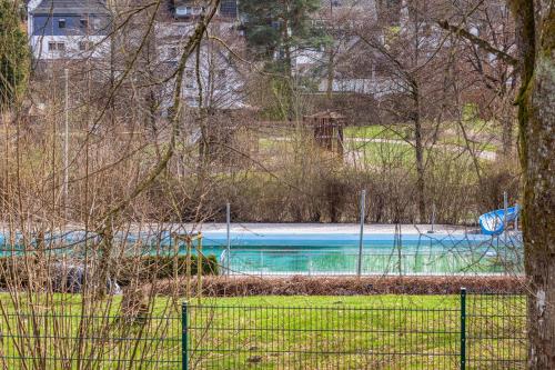 a swimming pool with a slide in a park at Ferienwohnung Greitemann in Eslohe