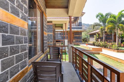 a balcony of a house with chairs on it at Hillside Resort Lonavala - Pawna - Mountain View in Lonavala