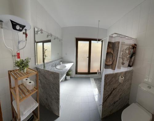 a white bathroom with a sink and a shower at Chalet con piscina privada en Calles in Calles