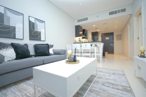 a living room with a couch and a table at Business Bay 1BR Gem Luxe Living in Dubai