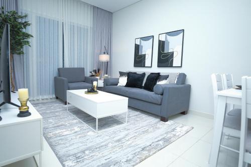 a living room with a couch and a coffee table at Business Bay 1BR Gem Luxe Living in Dubai