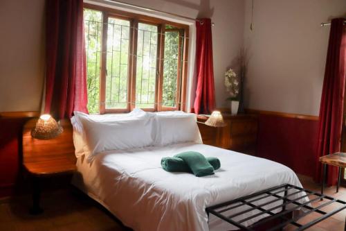 a bedroom with a bed with a green towel on it at The Ultimate Lodge in Louis Trichardt