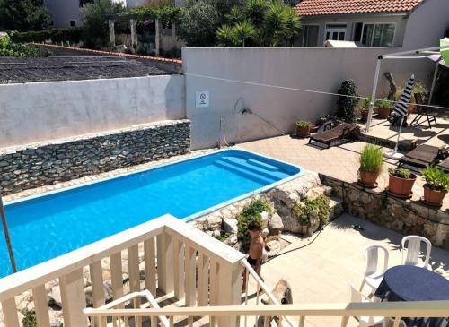 a swimming pool in the backyard of a house at Agava Apartments in Sutivan